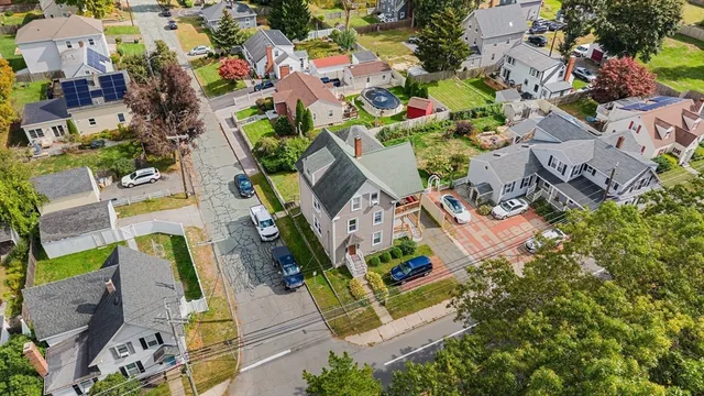 an aerial view of multiple houses with yard