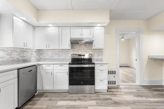 a kitchen with stainless steel appliances granite countertop a stove and a sink