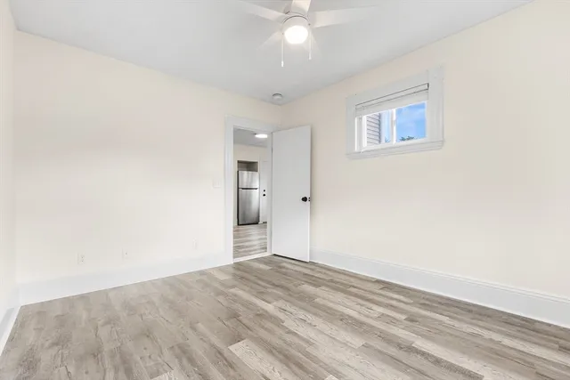 a view of empty room with wooden floor