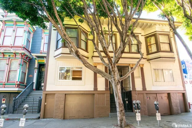 a front view of a brick house with large windows