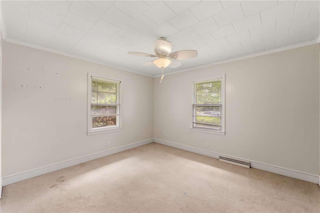 12 Dendy Street Pelzer, SC 29669 - Photo 15 of 31 A quiet bedroom with a ceiling fan offers two windows for ample natural illumination.
