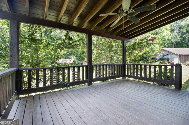 a view of a house with a big yard and large trees