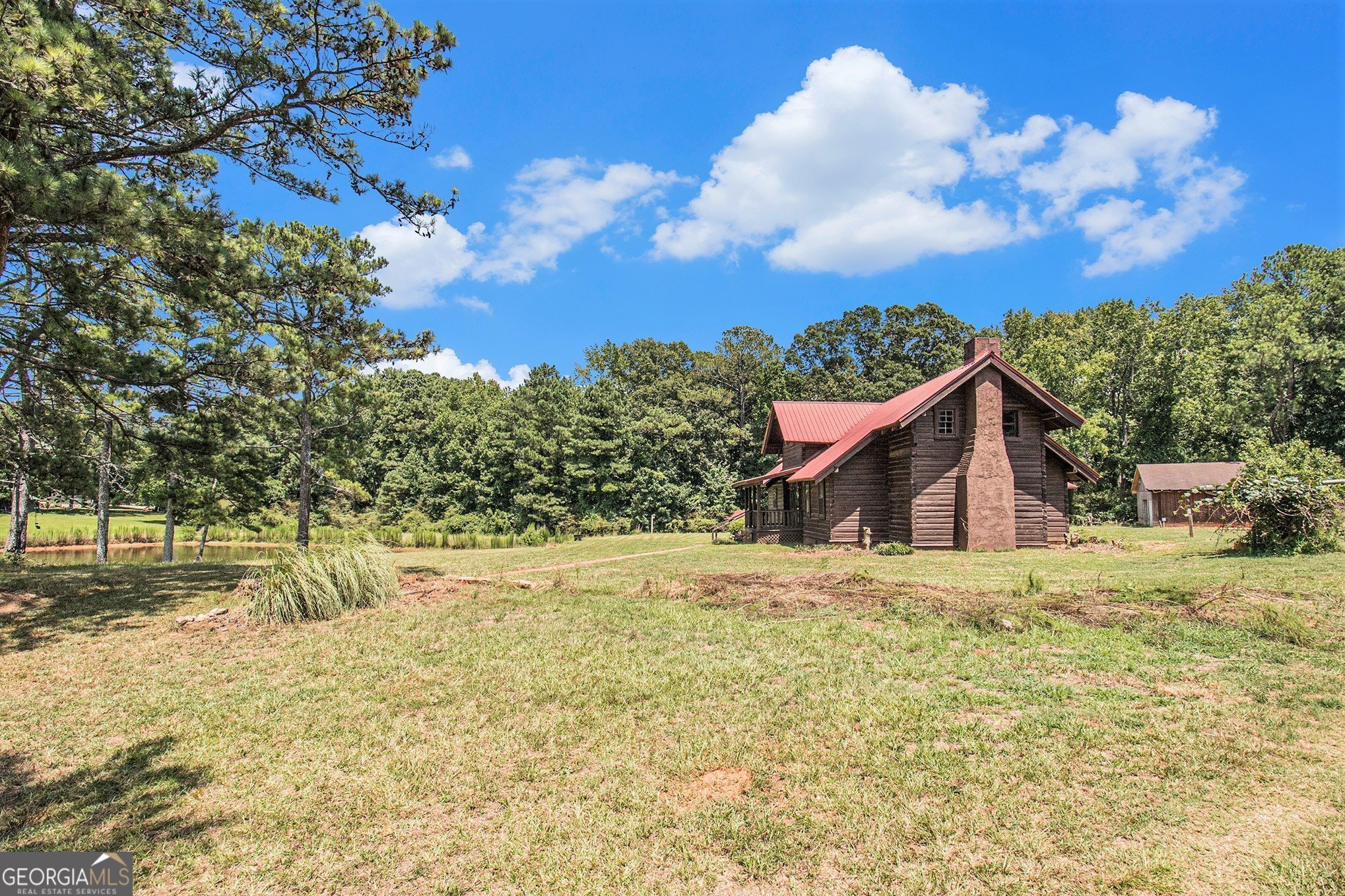 397 Highway 3 Street North Hampton, GA 30228 - Photo 25 of 32 a yellow house with trees in front of it
