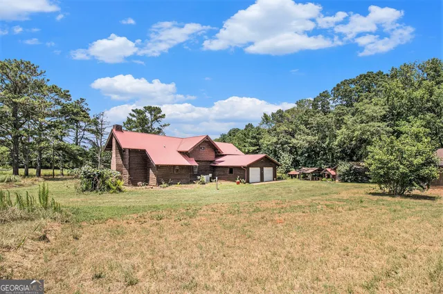 a view of a house with yard and sitting area