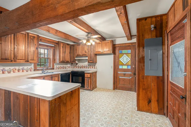 a kitchen with stainless steel appliances kitchen island granite countertop a refrigerator and a stove