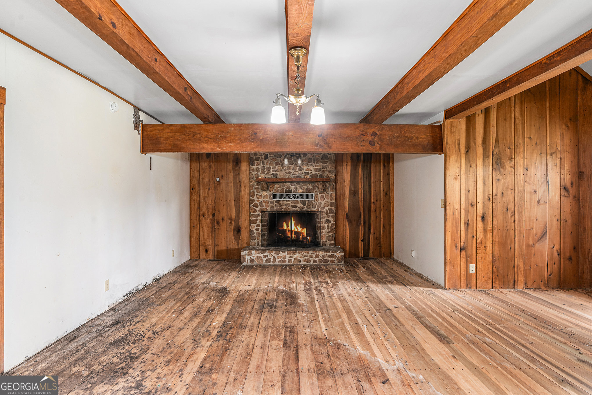 397 Highway 3 Street North Hampton, GA 30228 - Photo 10 of 32 a view of an empty room with wooden floor fireplace and a window