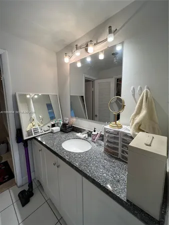 a bathroom with double vanity and a mirror