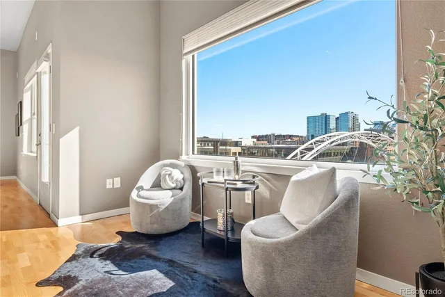 a living room with furniture and a floor to ceiling window