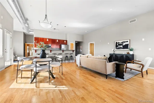 a living room with furniture a rug and a flat screen tv