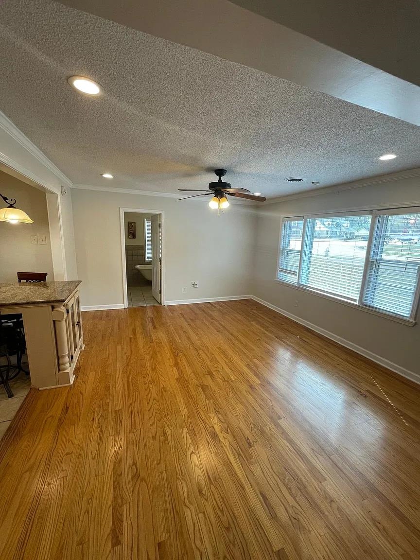 5568 Rich Road Memphis, TN 38120 - Photo 11 of 19 a view of empty room with wooden floor and fan