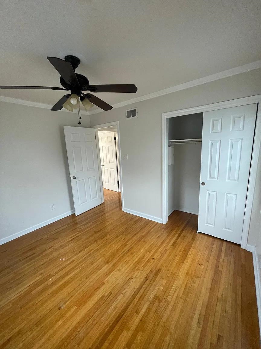 5568 Rich Road Memphis, TN 38120 - Photo 15 of 19 a view of a livingroom with wooden floor and a ceiling fan