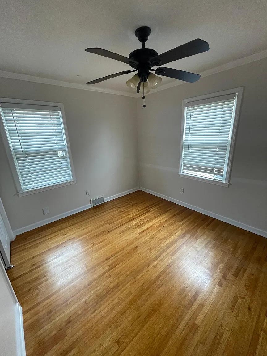5568 Rich Road Memphis, TN 38120 - Photo 16 of 19 a view of an empty room with wooden floor and a window