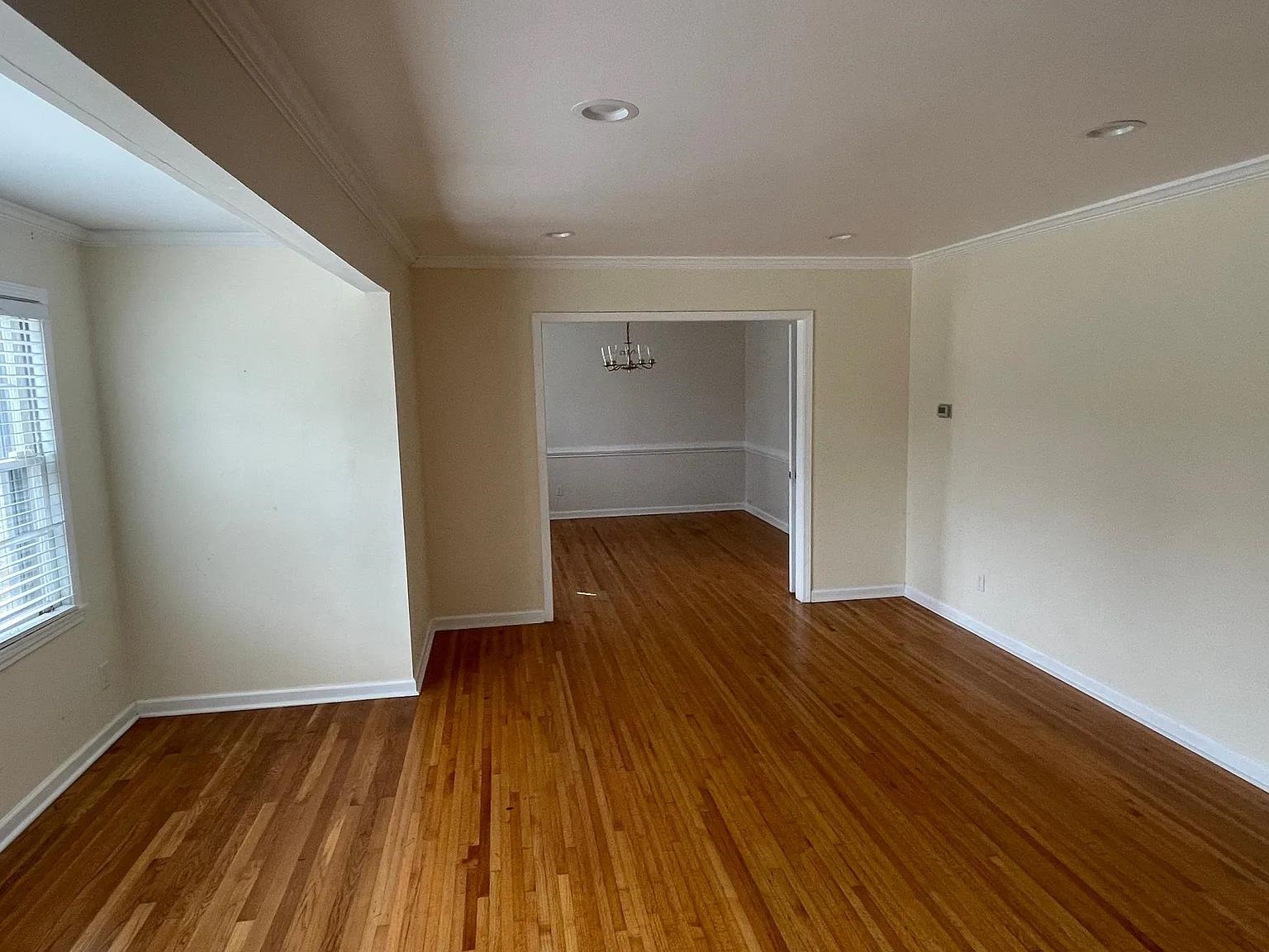 5568 Rich Road Memphis, TN 38120 - Photo 4 of 19 a view of empty room with wooden floor and fan