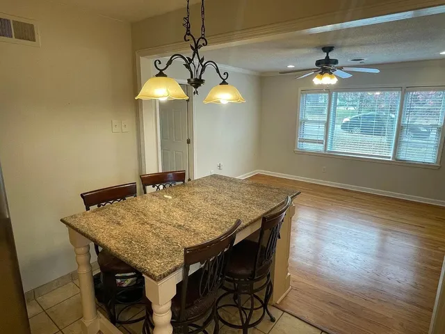 a kitchen with a table and a chandelier