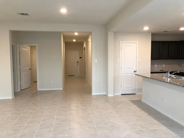 a view of a kitchen with a sink and a refrigerator
