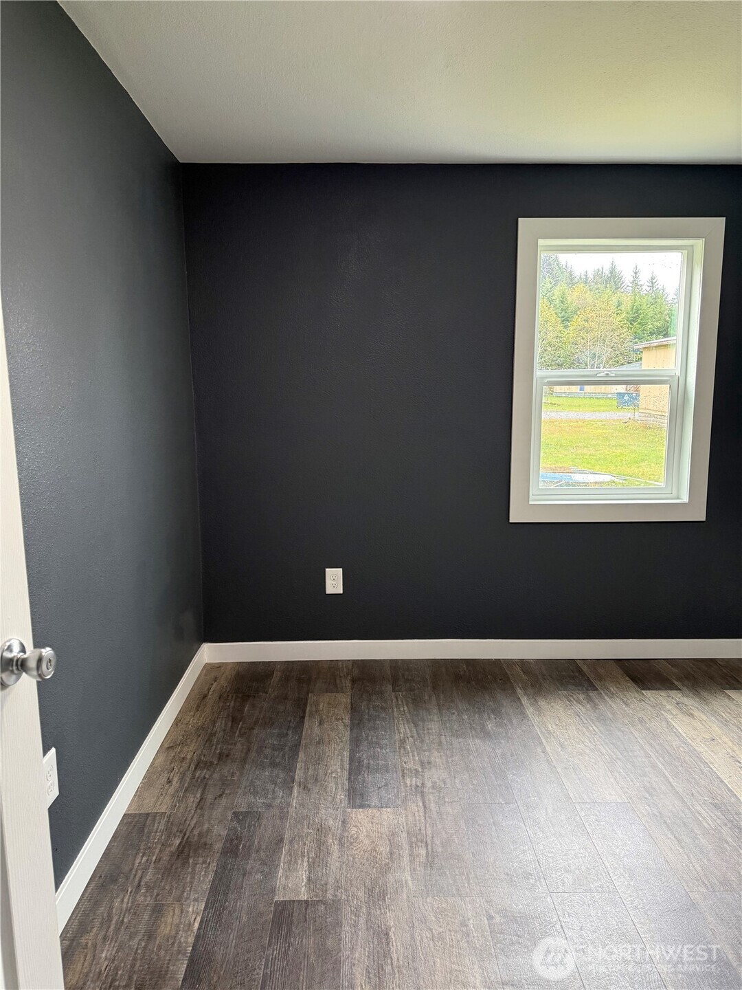 2610 Calawah Way, Unit 47 Forks, WA 98331 - Photo 11 of 17 an empty room with wooden floor and windows