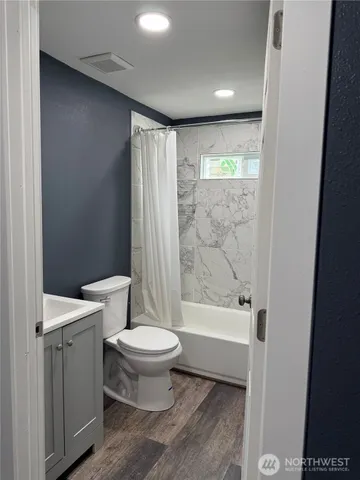 a bathroom with a toilet a sink and a bathtub