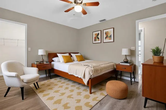 a bedroom with bed and wooden floor