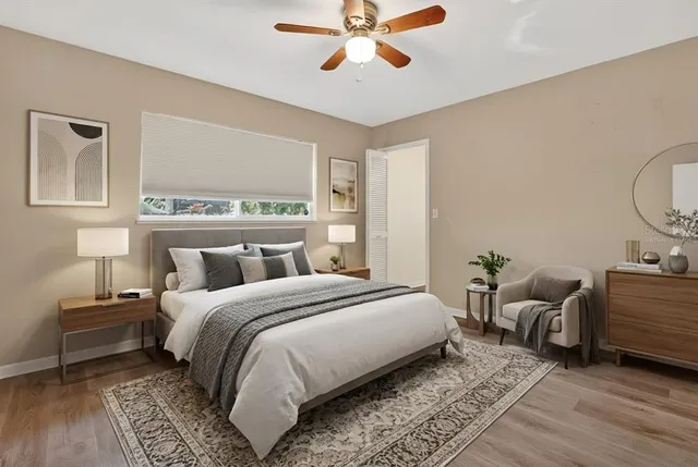 a bedroom with a bed and wooden floor