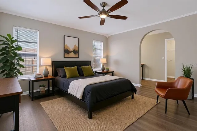 a bedroom with a bed a table and chair