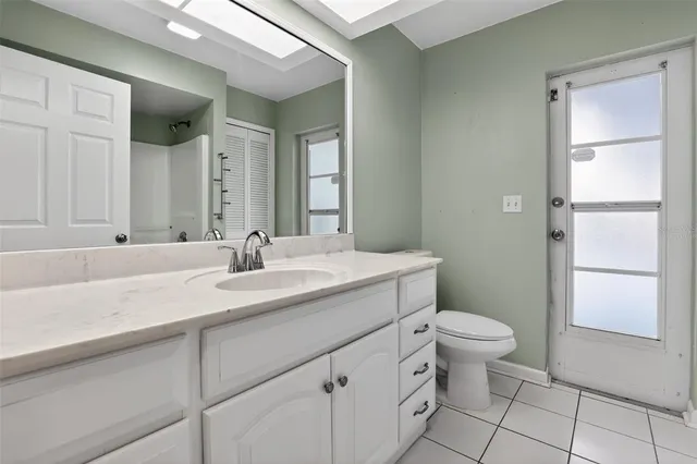 a bathroom with a sink a toilet and a mirror