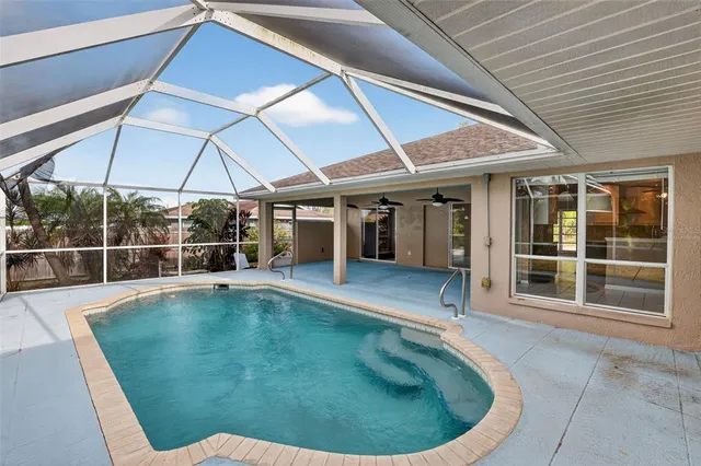 a view of a backyard with swimming pool