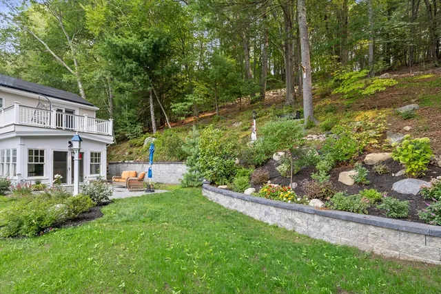 a front view of a house with a yard and green space