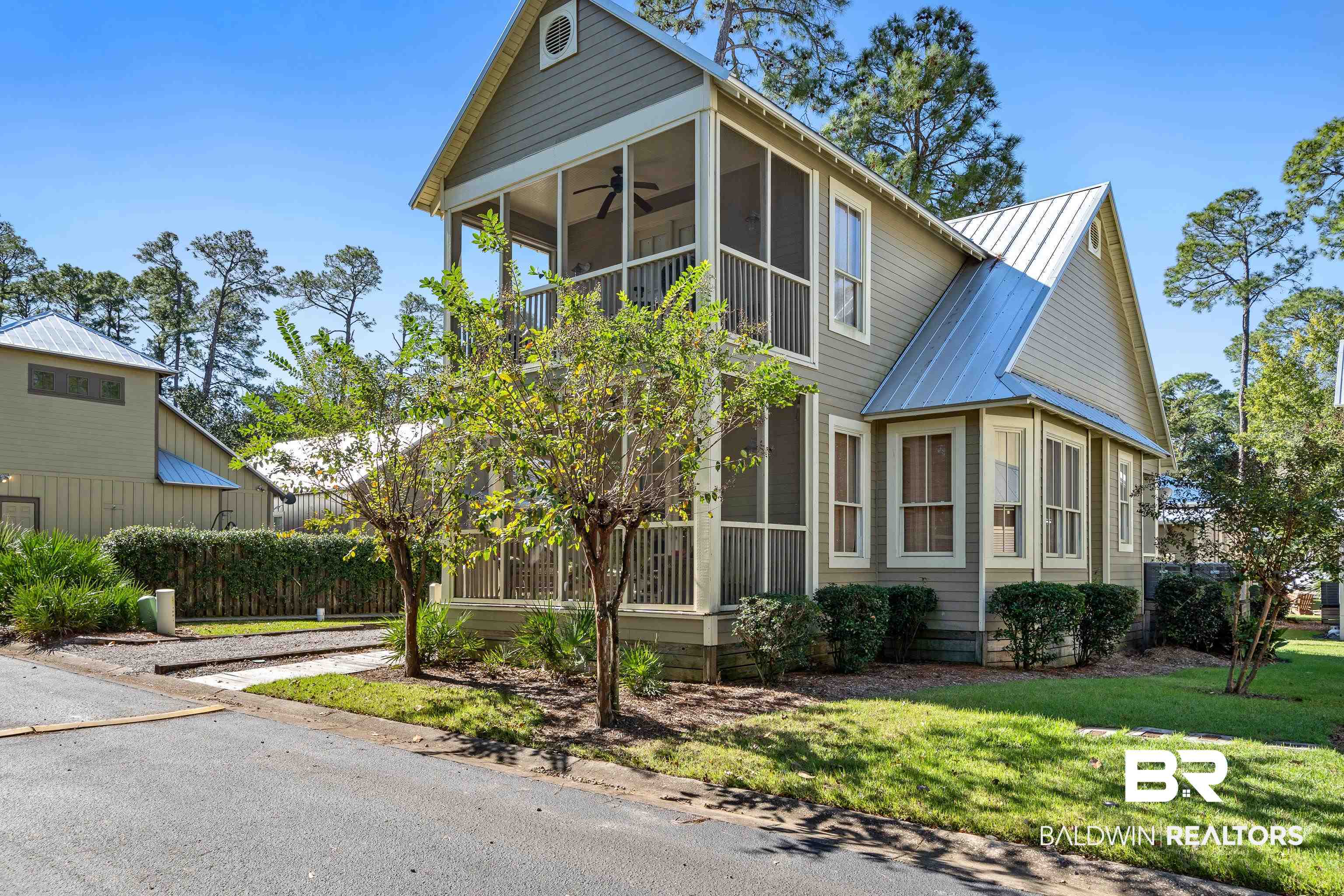 25773 Canal Road, Unit 10 Orange Beach, AL 36561 - Photo 1 of 40 View of front of home with screened porches and ceiling fans