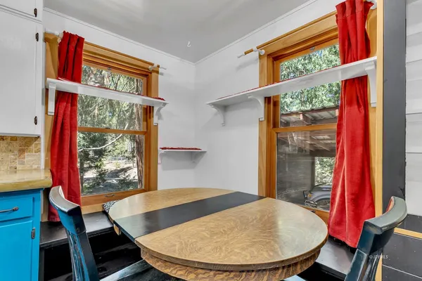 a view of a kitchen with a sink and large window