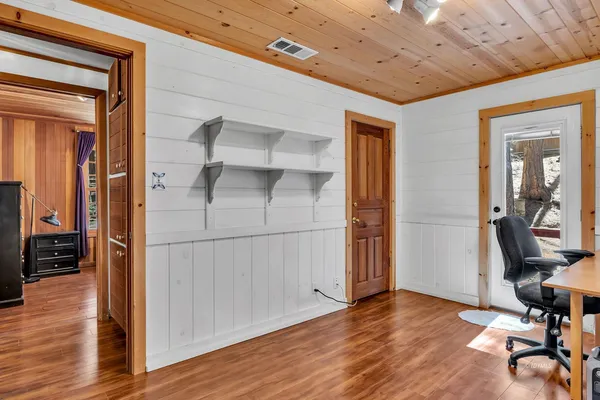 a bedroom with a bed dresser and a window