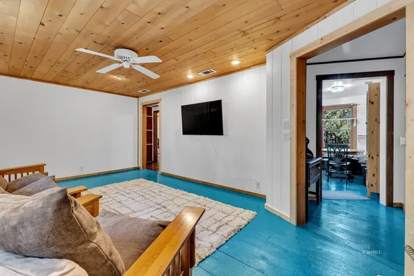 a kitchen with stainless steel appliances granite countertop a stove a sink dishwasher a dining table and chairs with wooden floor