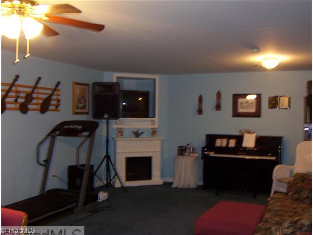 1020 Laurel Crest Road King, NC 27021 - Photo 6 of 9 Den/Family/Great Room. lower level room with a walk in closet ,free standing fireplace and shelve to put TV.