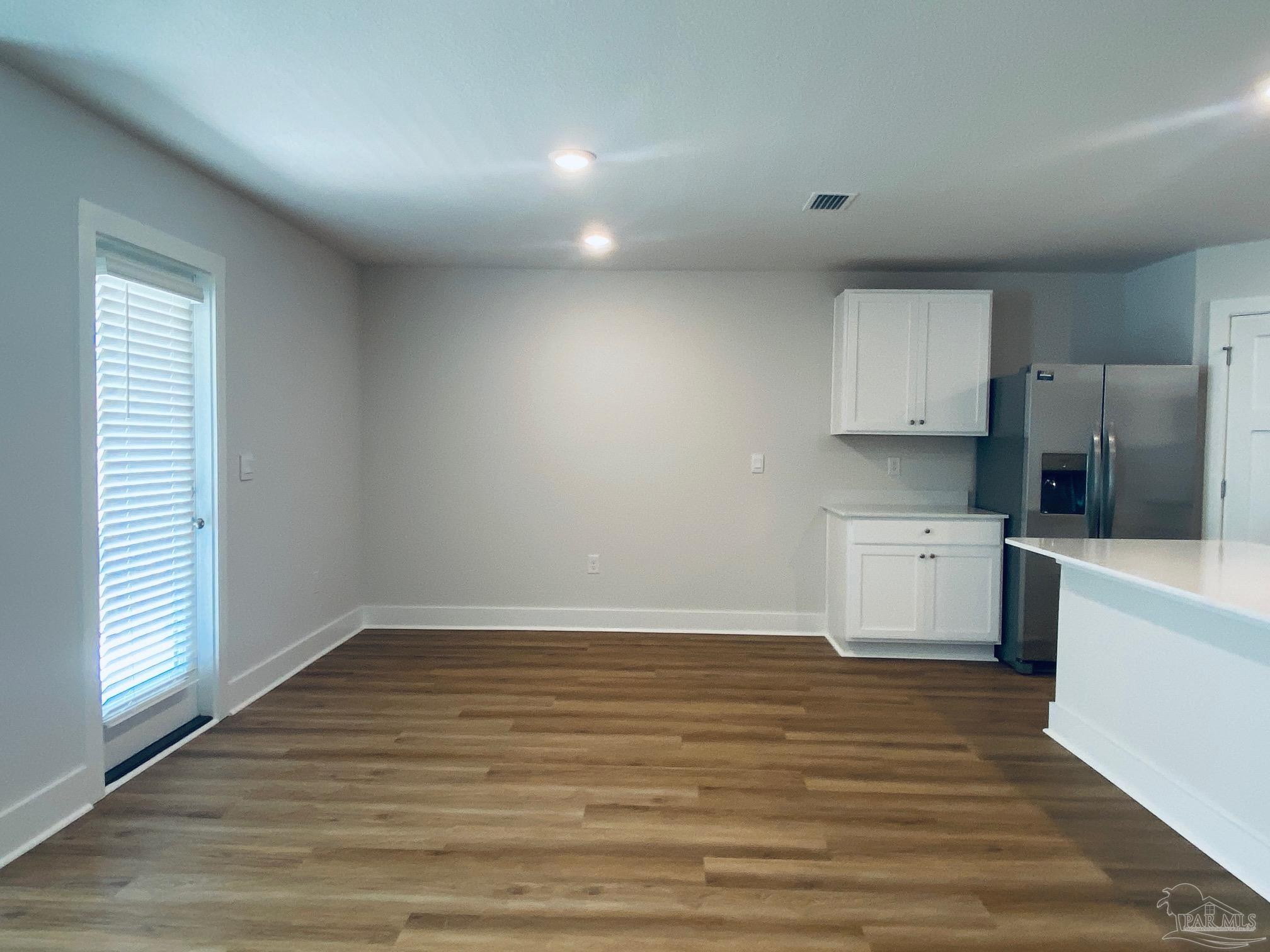 3021 Serviceberry Road Cantonment, FL 32533 - Photo 4 of 21 a view of a kitchen with a sink and dishwasher a stove top oven with wooden floor