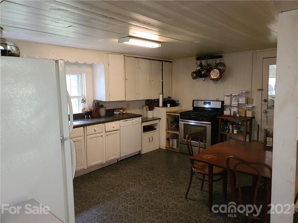 2680 Polk County Line Road Rutherfordton, NC 28139 - Photo 15 of 38 a kitchen with a sink cabinets and appliances