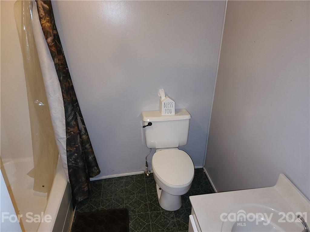 2680 Polk County Line Road Rutherfordton, NC 28139 - Photo 17 of 38 a white toilet sitting next to a sink