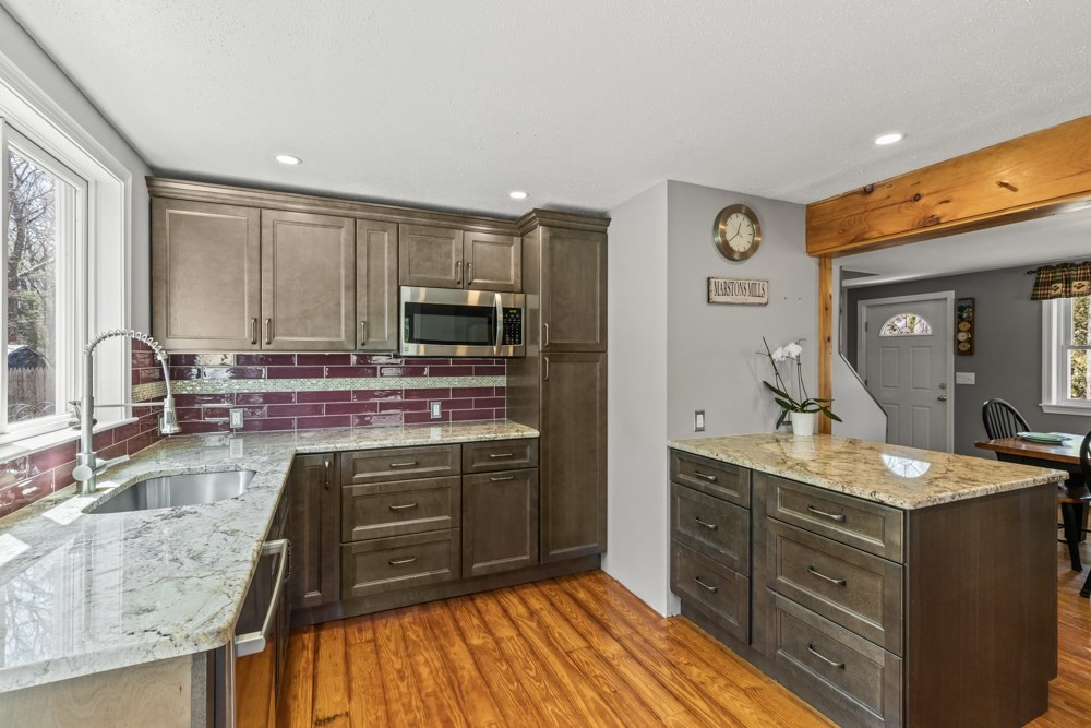 8 Trotters Lane Barnstable, MA 02648 - Photo 11 of 41 a kitchen with stainless steel appliances granite countertop a sink stove and cabinets