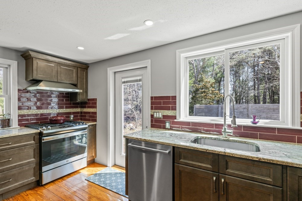 8 Trotters Lane Barnstable, MA 02648 - Photo 13 of 41 a kitchen with granite countertop a stove sink and microwave
