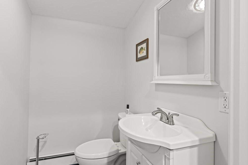 8 Trotters Lane Barnstable, MA 02648 - Photo 26 of 41 a bathroom with a sink a toilet and mirror