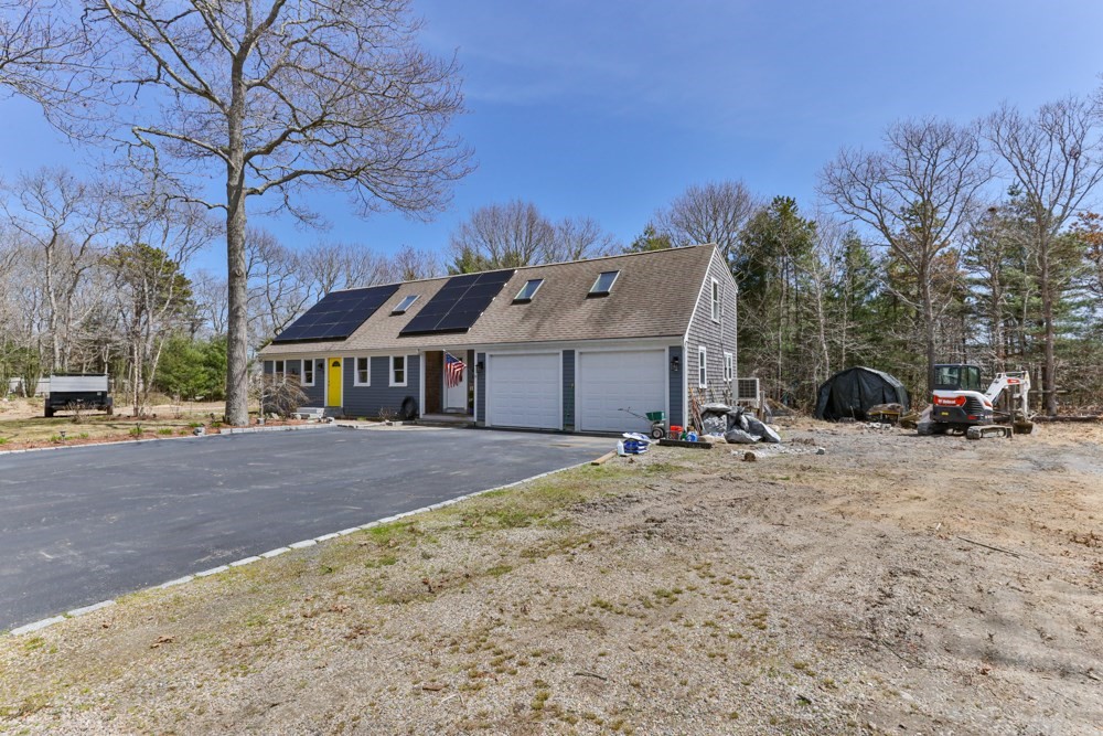 8 Trotters Lane Barnstable, MA 02648 - Photo 28 of 41 a front view of a house with a yard and garage