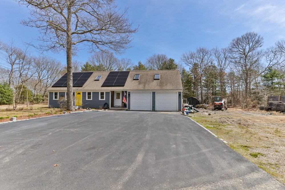 8 Trotters Lane Barnstable, MA 02648 - Photo 30 of 41 a front view of a house with a yard covered with snow and trees