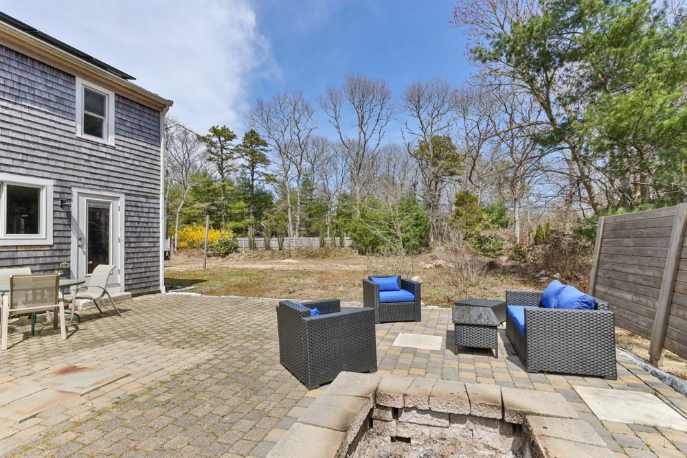 8 Trotters Lane Barnstable, MA 02648 - Photo 33 of 41 a view of a patio with table and chairs and potted plants