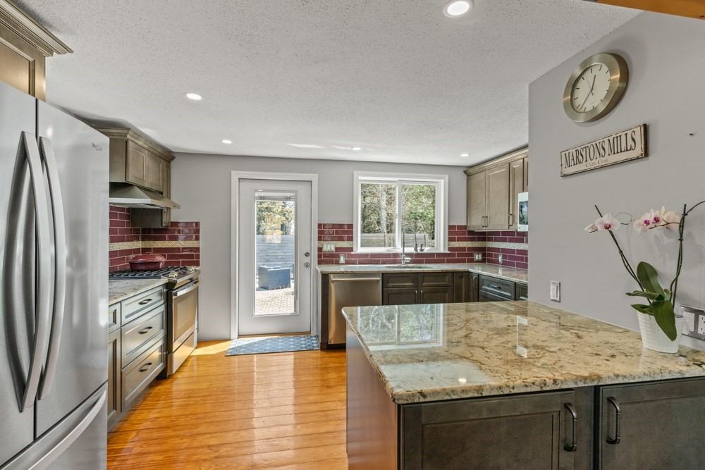 8 Trotters Lane Barnstable, MA 02648 - Photo 9 of 41 a kitchen with stainless steel appliances granite countertop a refrigerator and a stove top oven