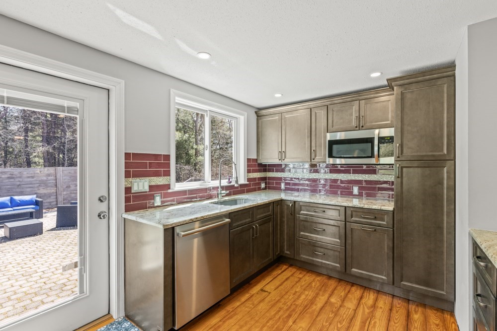 8 Trotters Lane Barnstable, MA 02648 - Photo 10 of 41 a kitchen with a sink stove and microwave