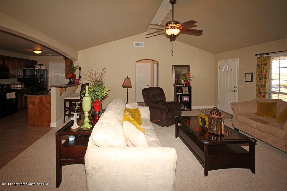 3901 Arden Road Amarillo, TX 79118 - Photo 6 of 24 a living room with furniture fireplace and a chandelier