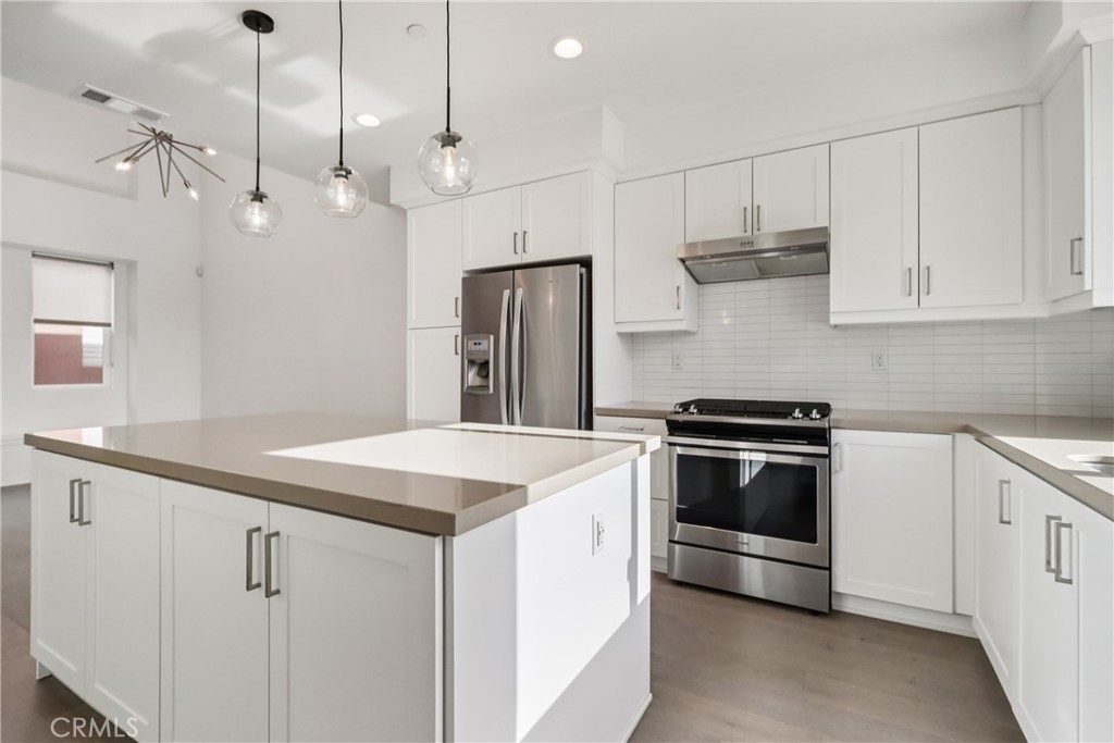 170 Fable Irvine, CA 92618 - Photo 12 of 27 a kitchen that has a sink a stove and a refrigerator