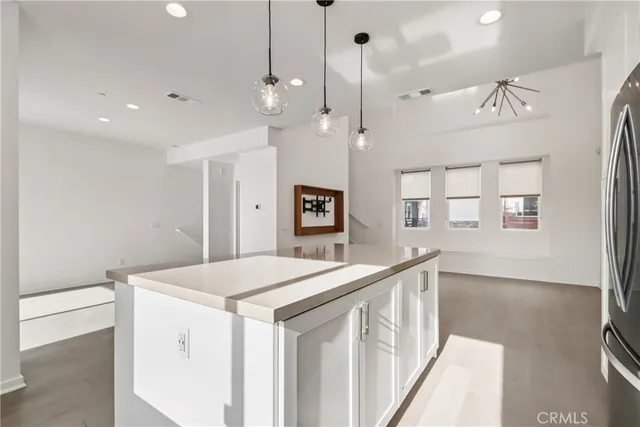 a view of a hallway with wooden floor and chandelier