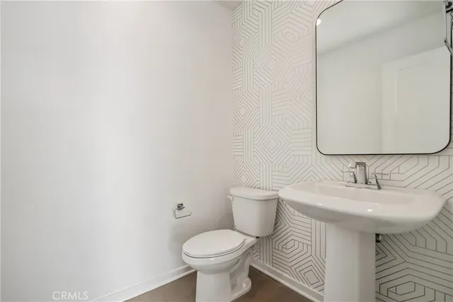 a bathroom with a sink toilet and mirror