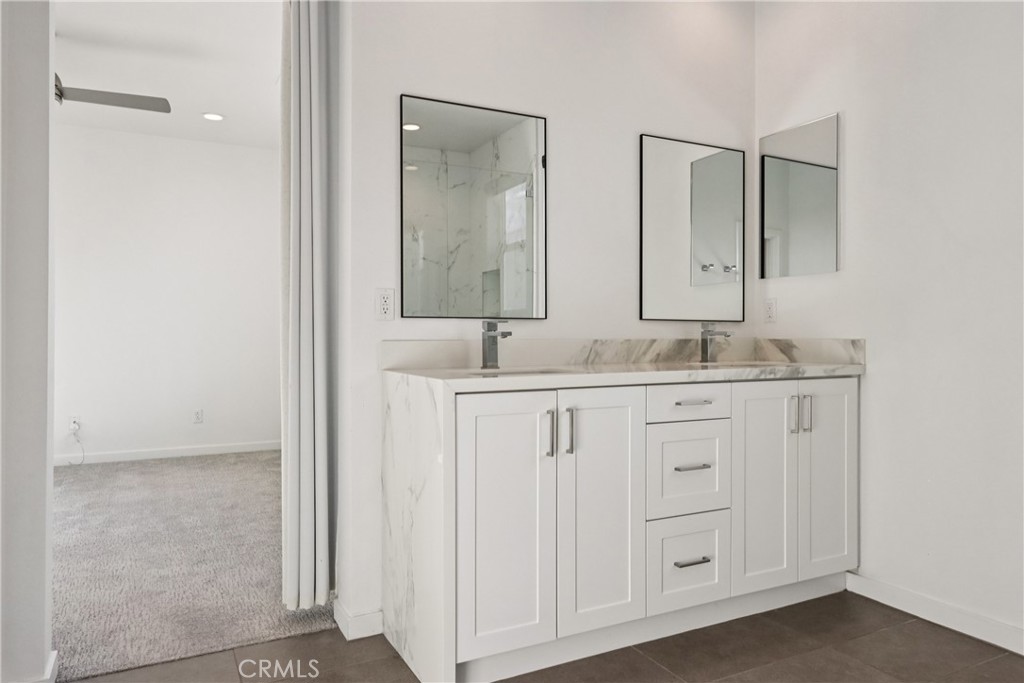 170 Fable Irvine, CA 92618 - Photo 25 of 27 a bathroom with a granite countertop sink and a mirror