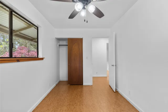 a view of a hallway with a chandelier fan