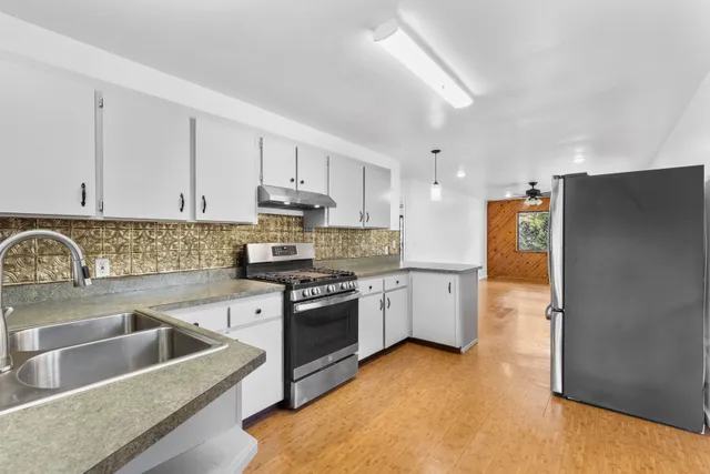 a kitchen with a sink stove and refrigerator